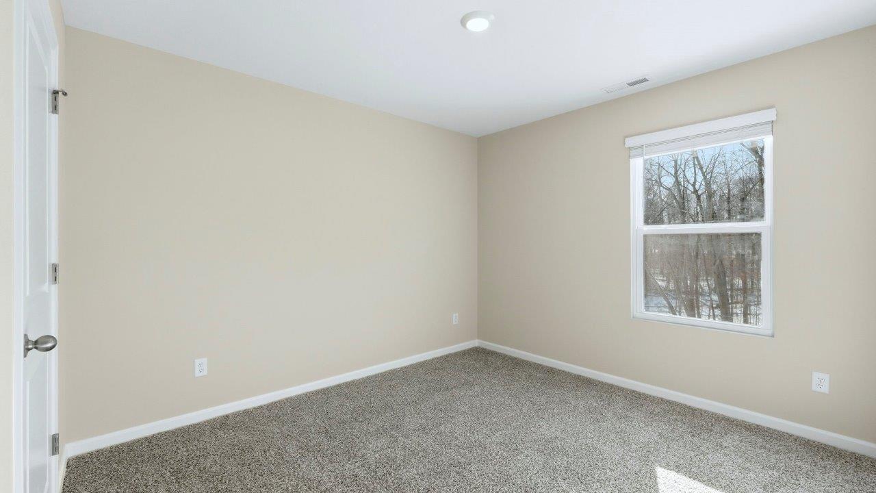 bedroom 3 with elk beige carpets, single window, and closet