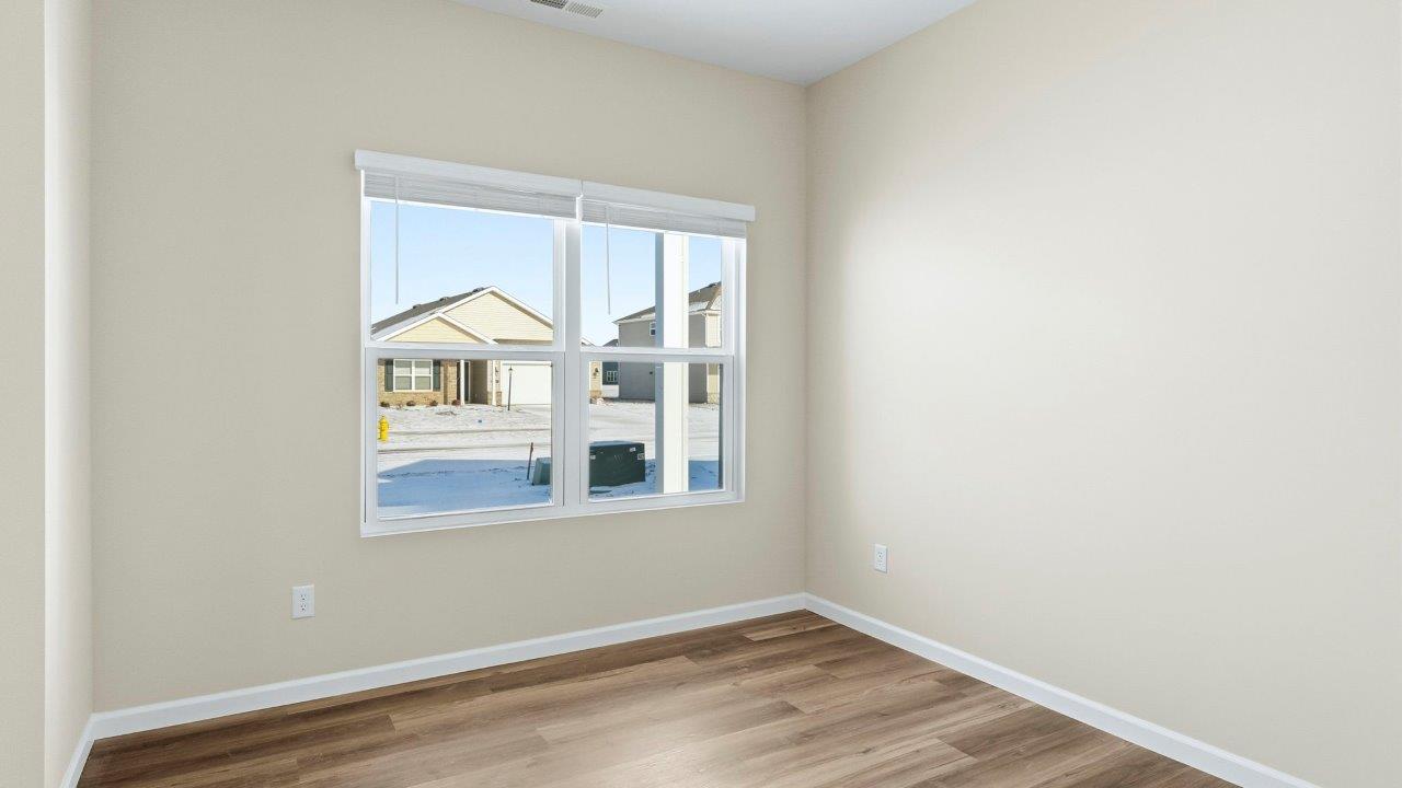 first floor study off of foyer with Mohawk Eastmont LVP flooring, 2 windows, and popular grey walls
