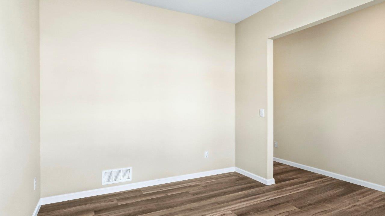 first floor study off of foyer with Mohawk Eastmont LVP flooring, 2 windows, and popular grey walls