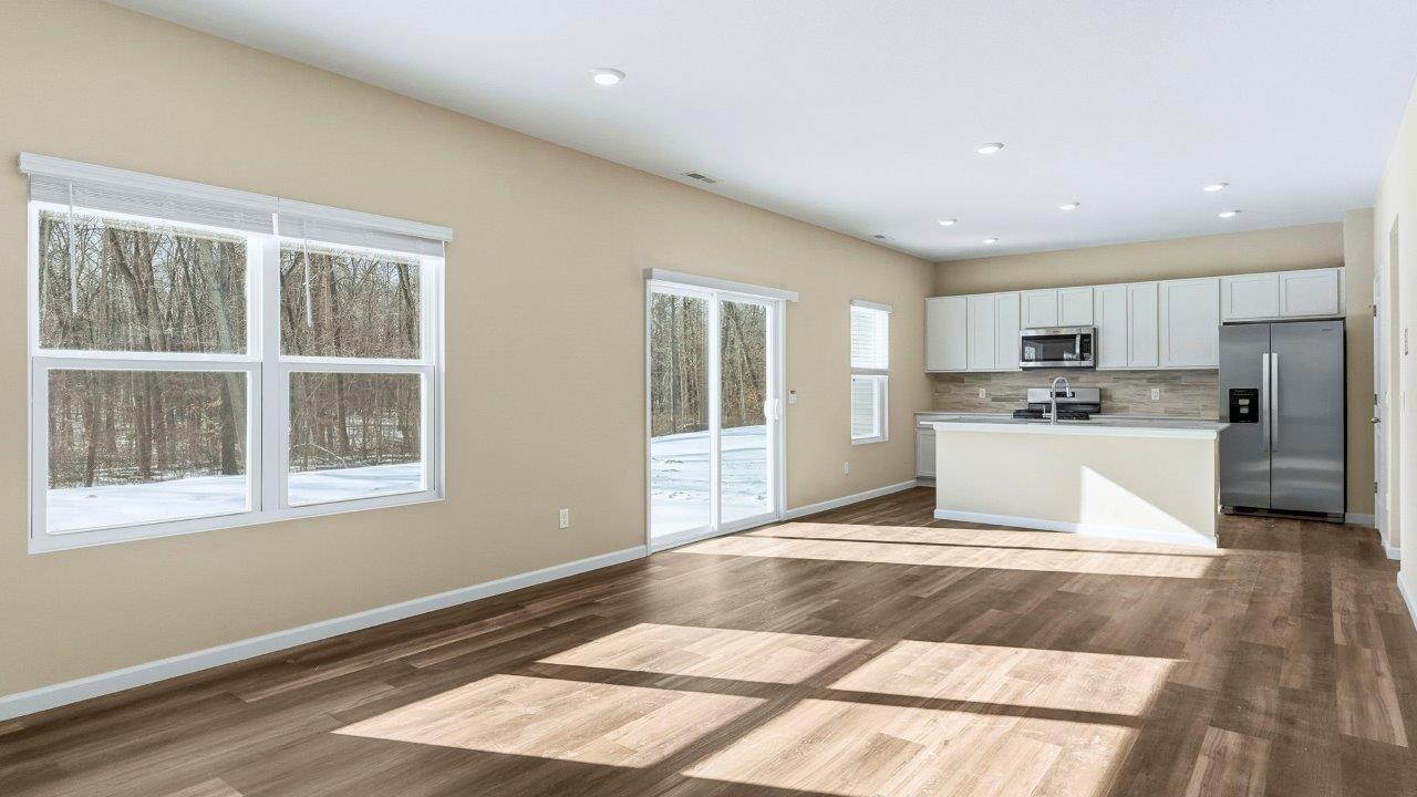 living room with Mohawk Eastmont flooring and many windows for natural lighting