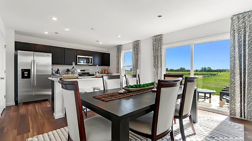 Bellamy open layout dining and kitchen with lvp and sliding door to backyard patio