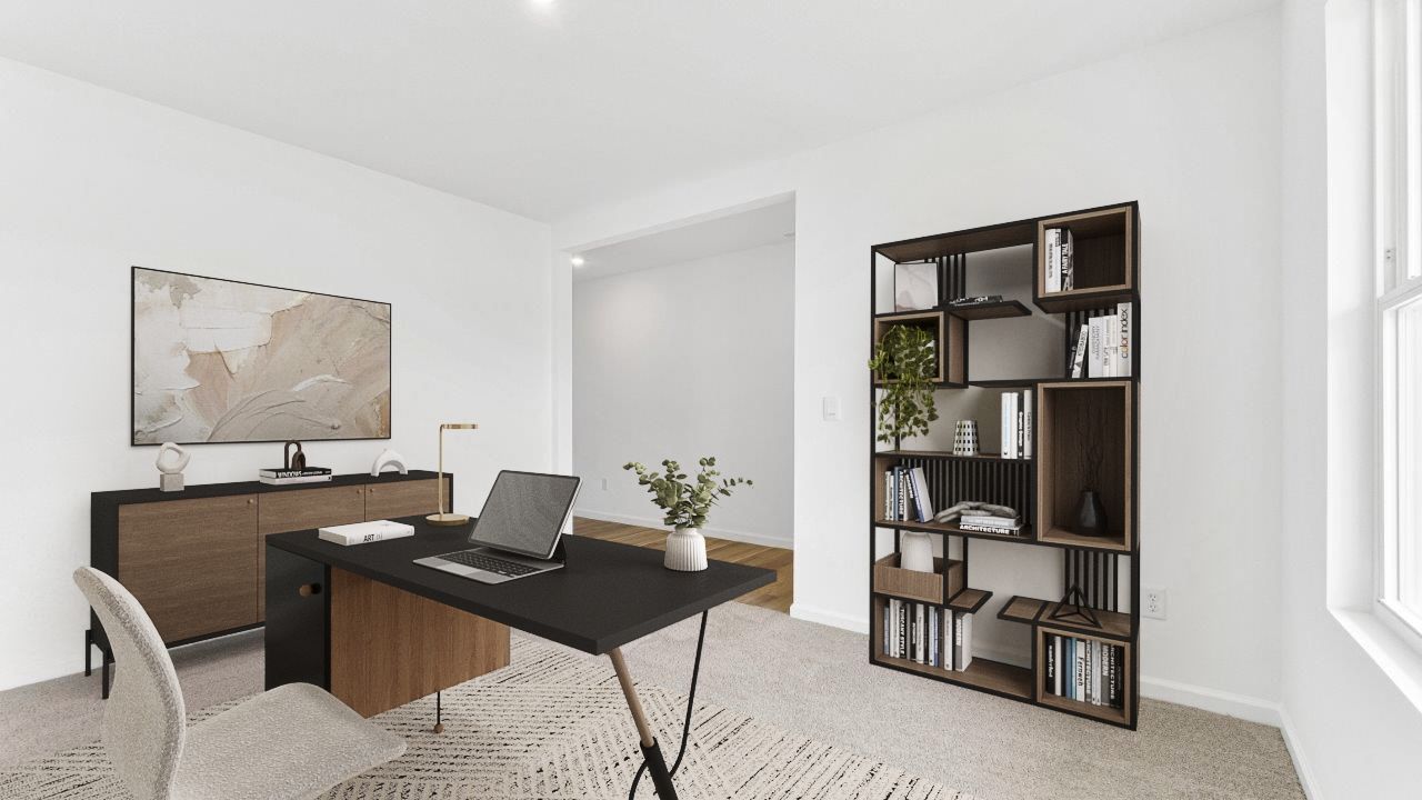 first floor study furnished as office located at front of home with carpet flooring, 2 windows, and white walls