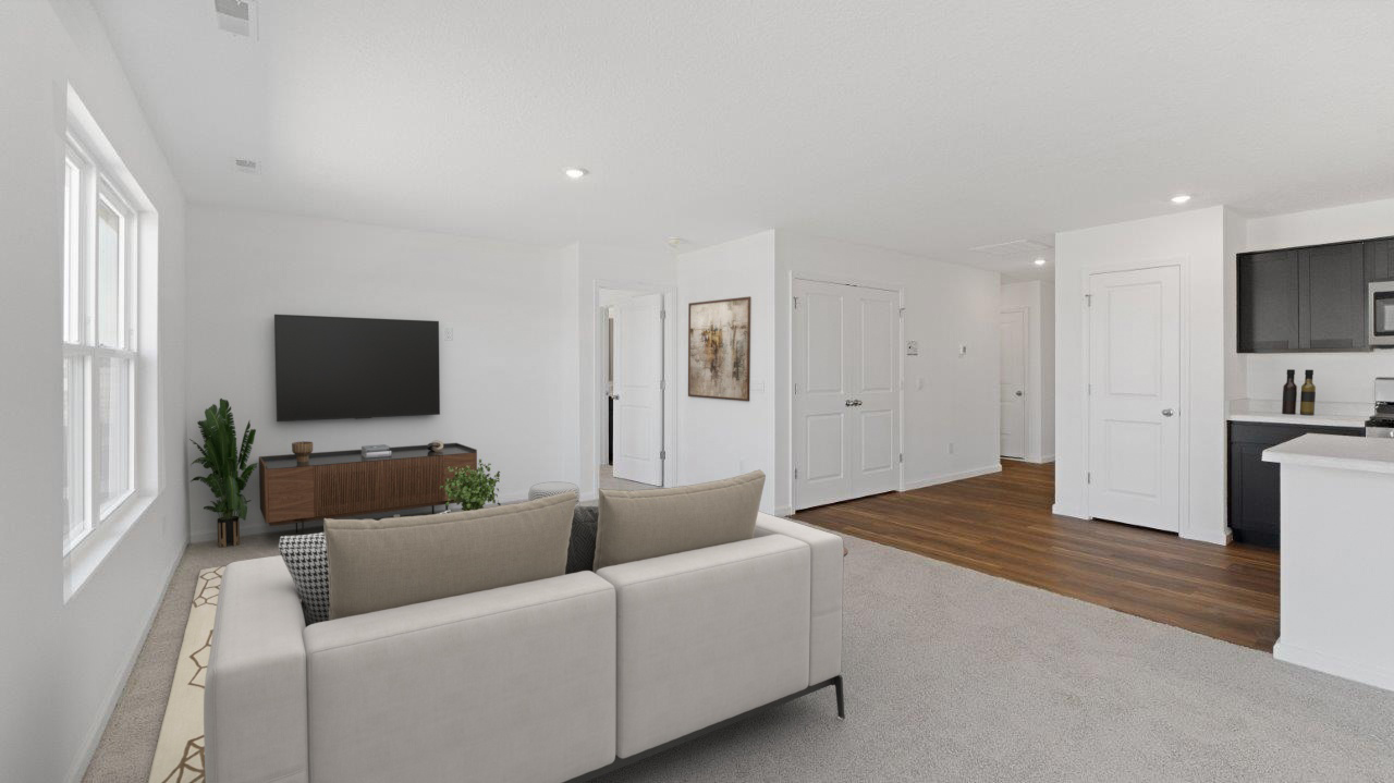 furnished living room with natural lighting from 2 windows, carpet flooring, and white walls