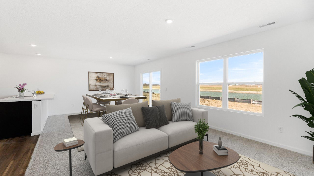 furnished living room with natural lighting from 2 windows, carpet flooring, and white walls