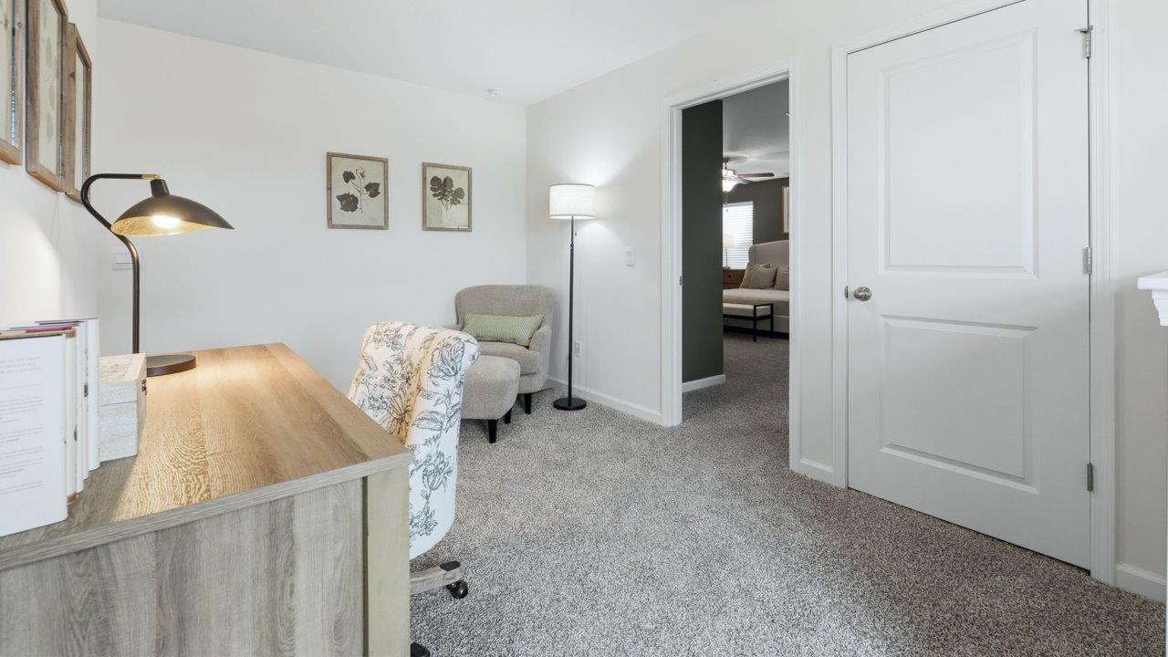 thunderhawk elm model home loft furnished as office with carpet flooring