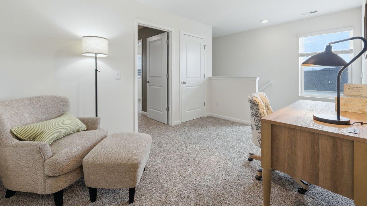 thunderhawk elm model home loft furnished as office with carpet flooring