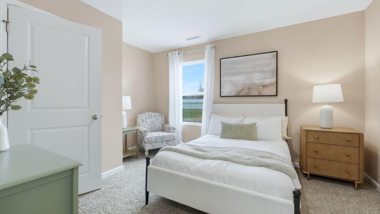 thunderhawk model home elm plan first floor guest bedroom with single window, beige carpet, light brown walls, and closet