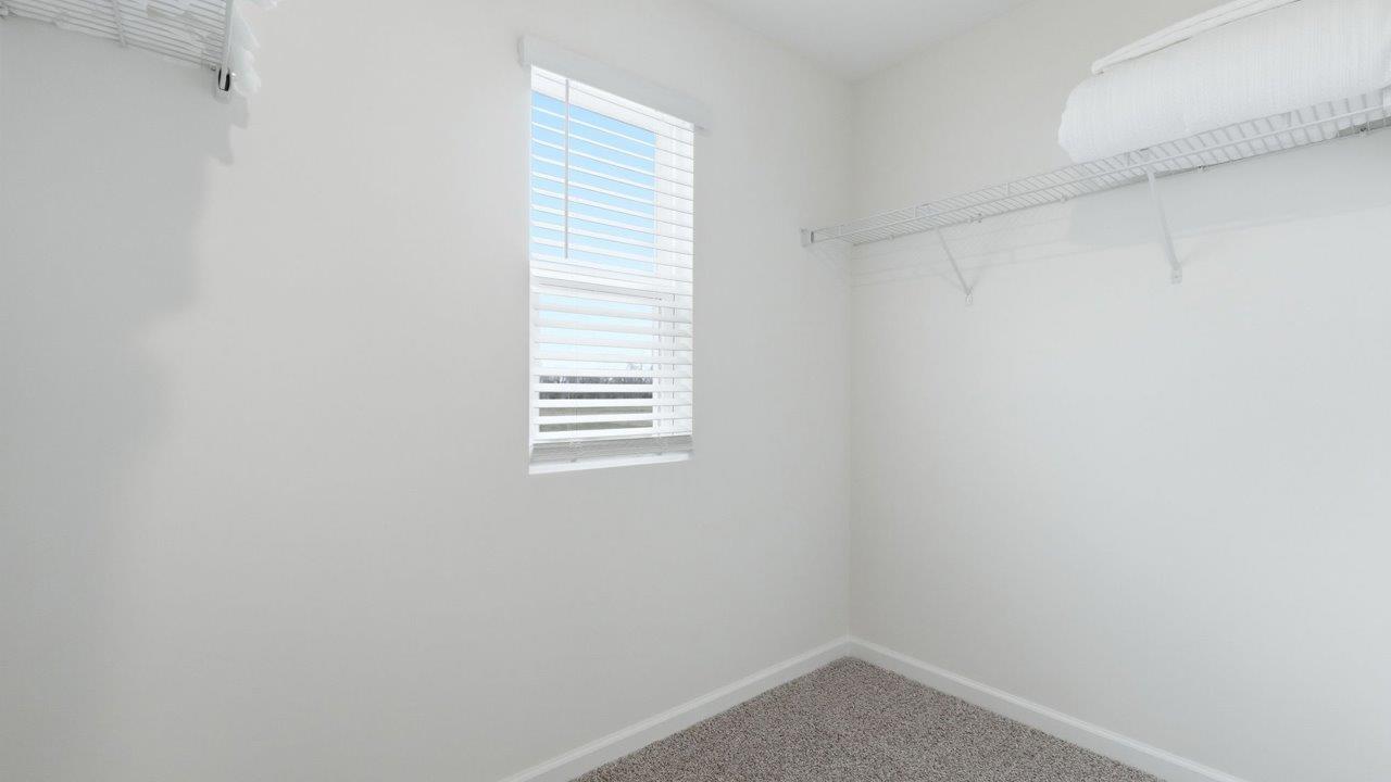 thunderhawk elm model home primary ensuite walk in closet with built in shelving