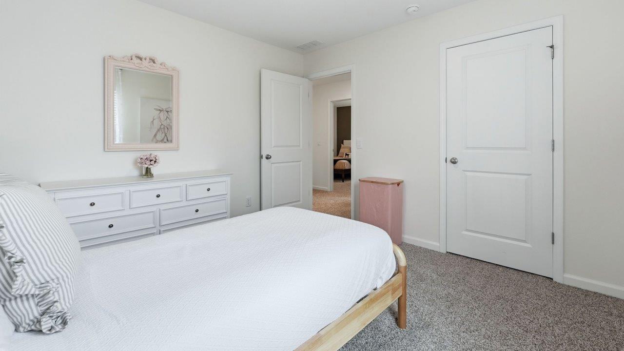 thunderhawk elm model home bedroom 3 with carpet flooring and pink walls