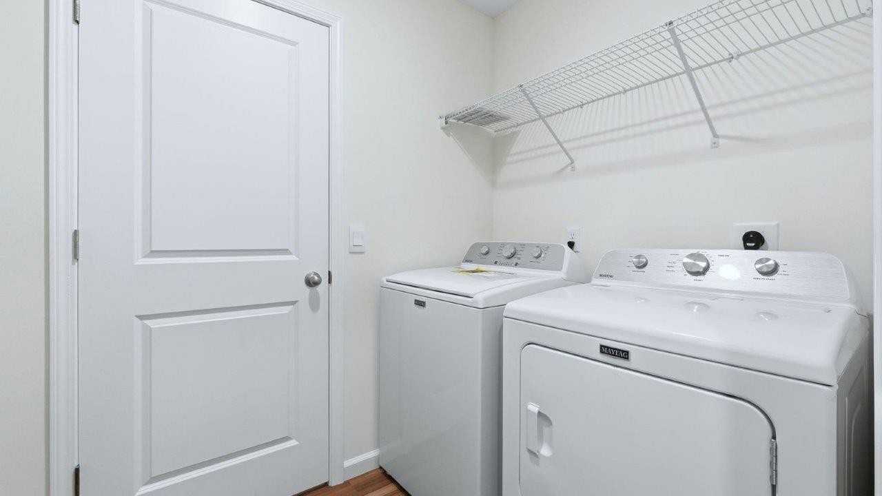 thunderhawk model home elm plan second floor laundry room with shelving and LVP flooring