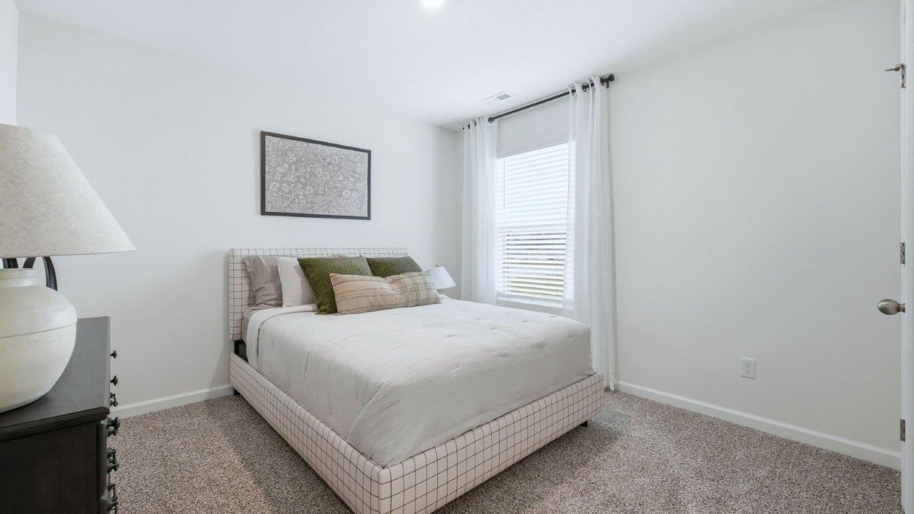 thunderhawk model home elm plan bedroom 3 with white walls, beige carpet, closet, and 1 window