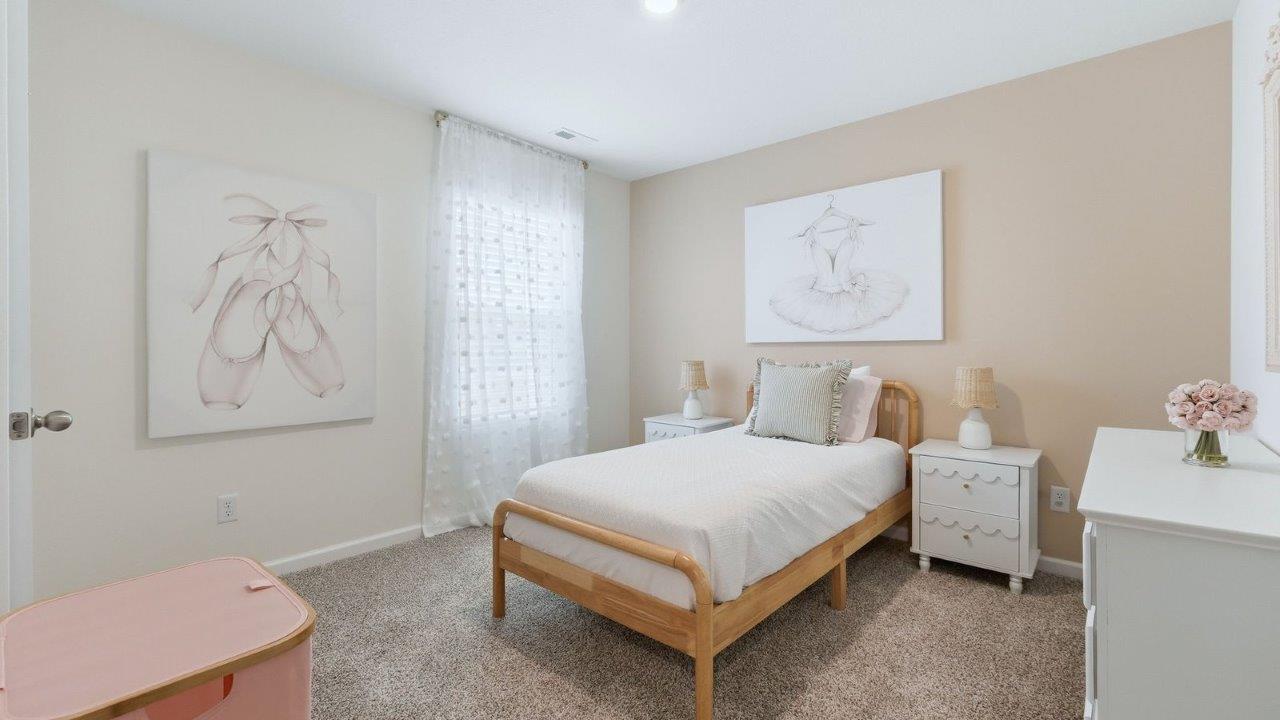 thunderhawk model home elm plan bedroom 4 with beige carpet, light pink walls, 1 window, and closet