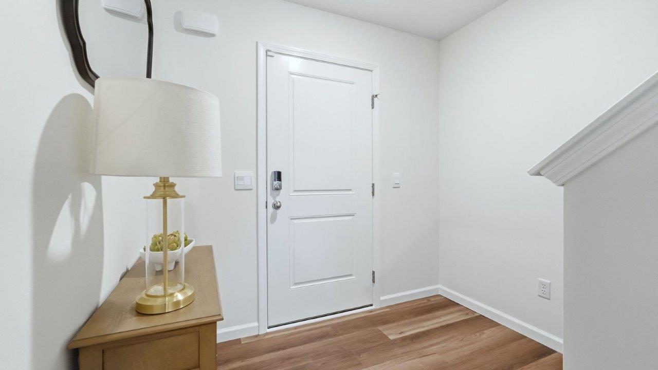 thunderhawk model home elm plan foyer with white walls and mohawk lvp flooring