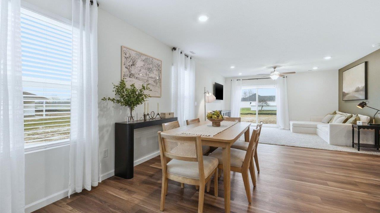 thunderhawk model home elm plan casual dining room with mohawk lvp flooring and plenty of natural lighting near kitchen and living room