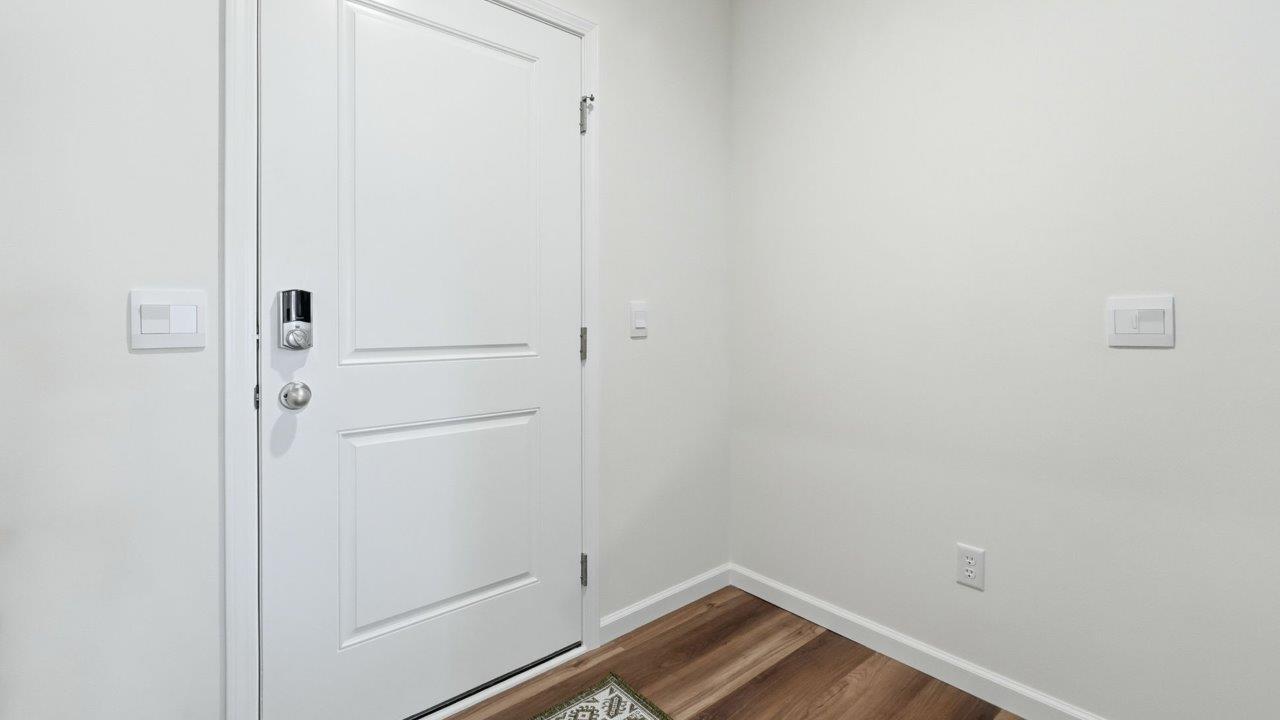 thunderhawk elm front door and foyer with white walls and mohawk lvp flooring