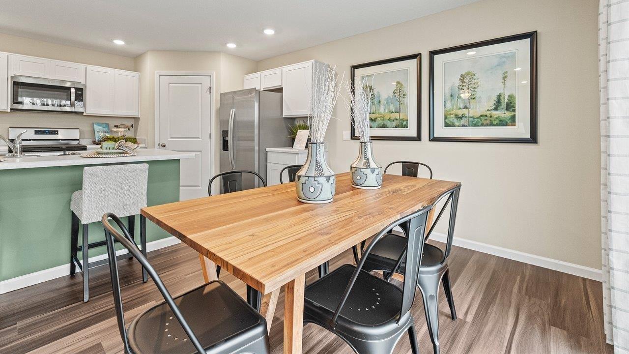 harmony dining room with lvp and sliding glass door to backyard