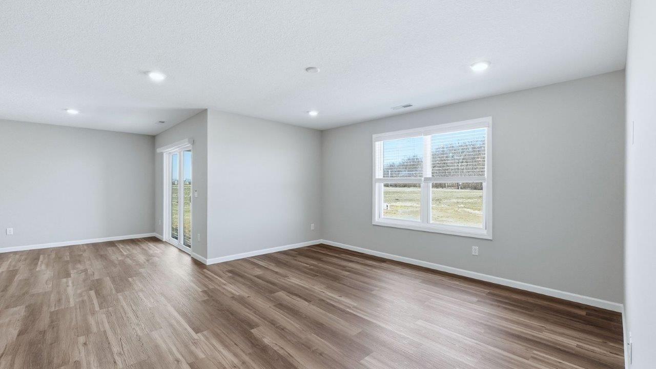 living room with lvp, 2 windows, and popular grey walls