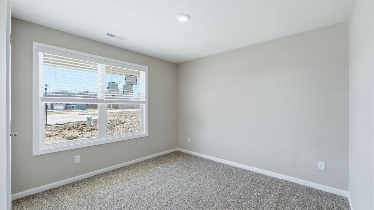 bedroom 2 with beige carpet, 2 windows, and popular grey walls