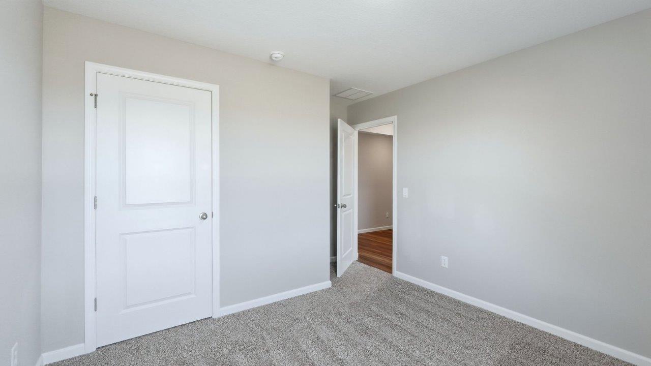 bedroom 3 with beige carpet, 1 windows, and popular grey walls