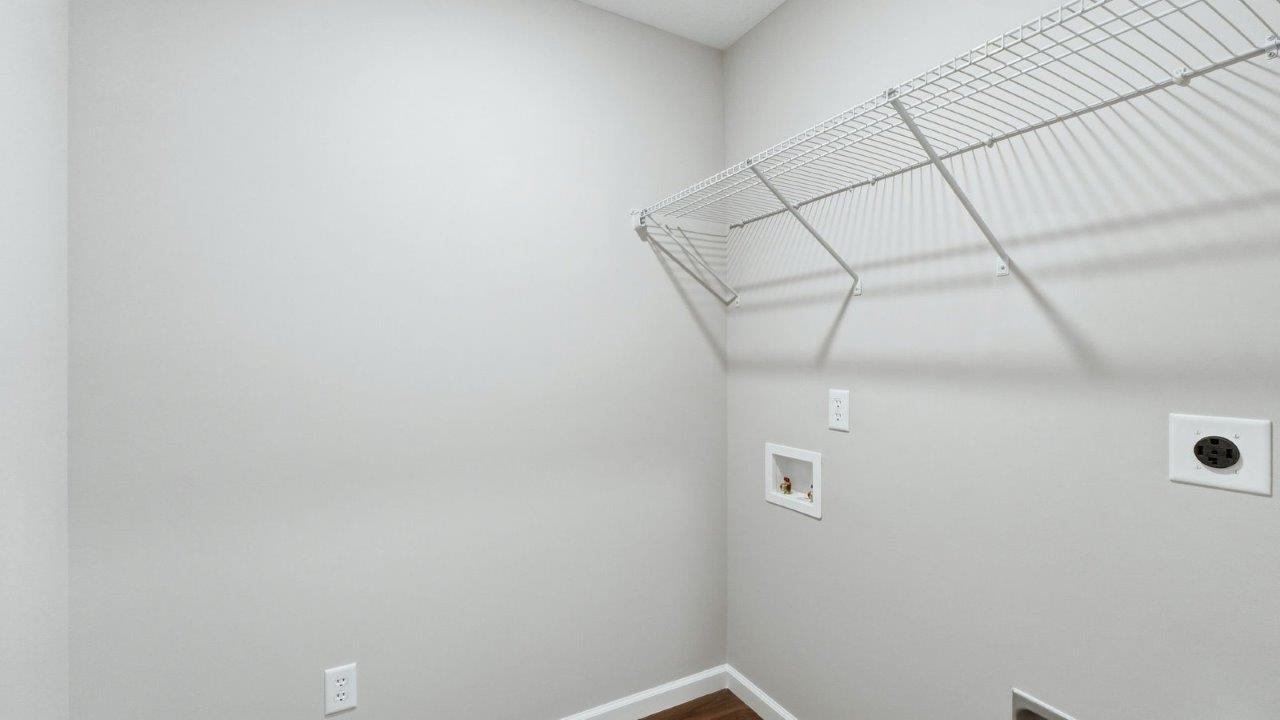 laundry room with lvp, built-in shelf, and hookups