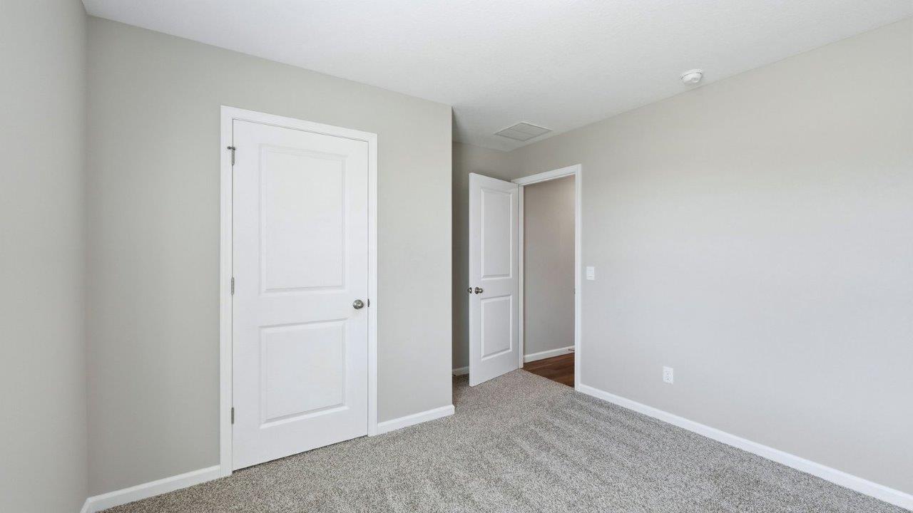 bedroom 4 with beige carpet, 1 windows, and popular grey walls