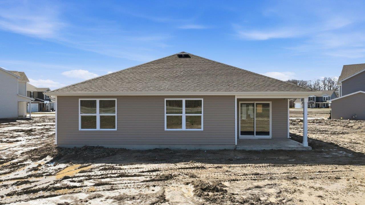 backyard and rear covered patio with spacious yard