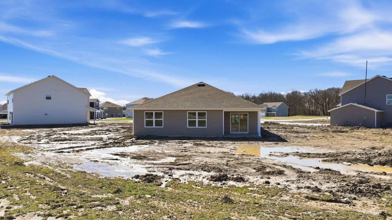 backyard and rear covered patio with spacious yard