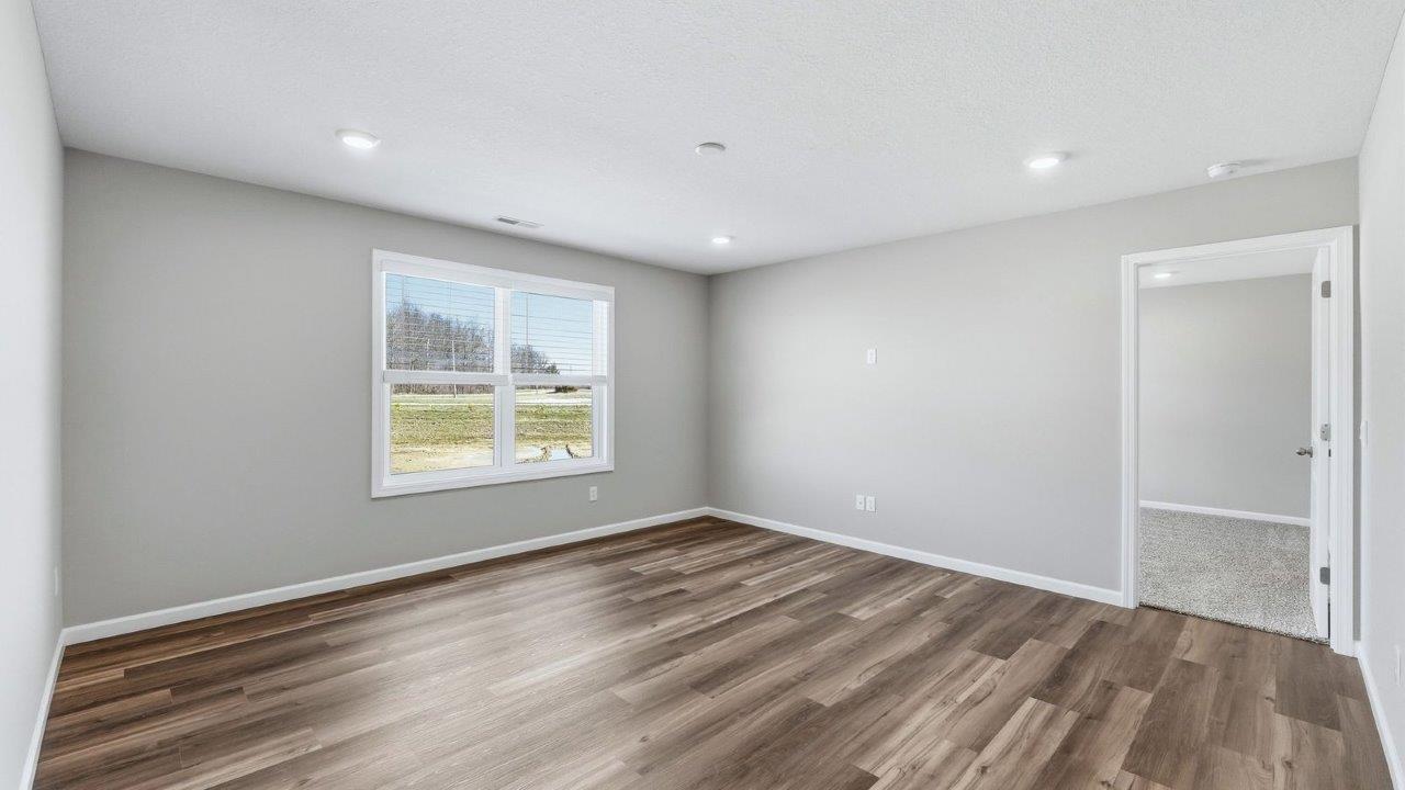 living room with lvp, 2 windows, and popular grey walls