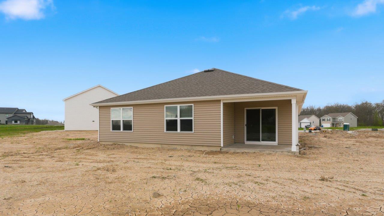 rear exterior with covered porch and spacious backyard