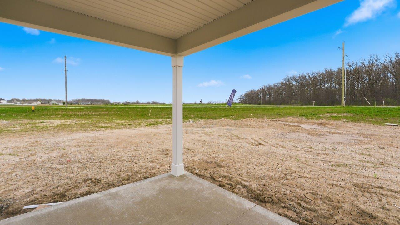 rear exterior with covered porch and spacious backyard