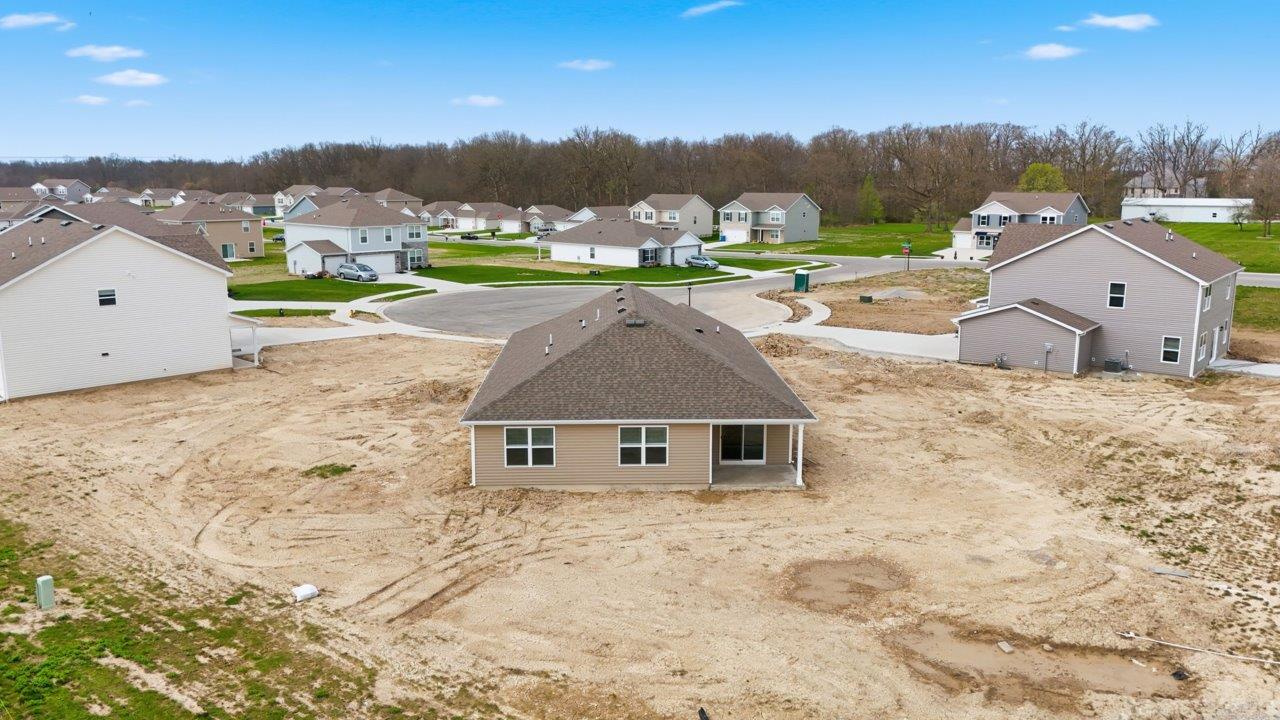 rear exterior with covered porch and spacious backyard