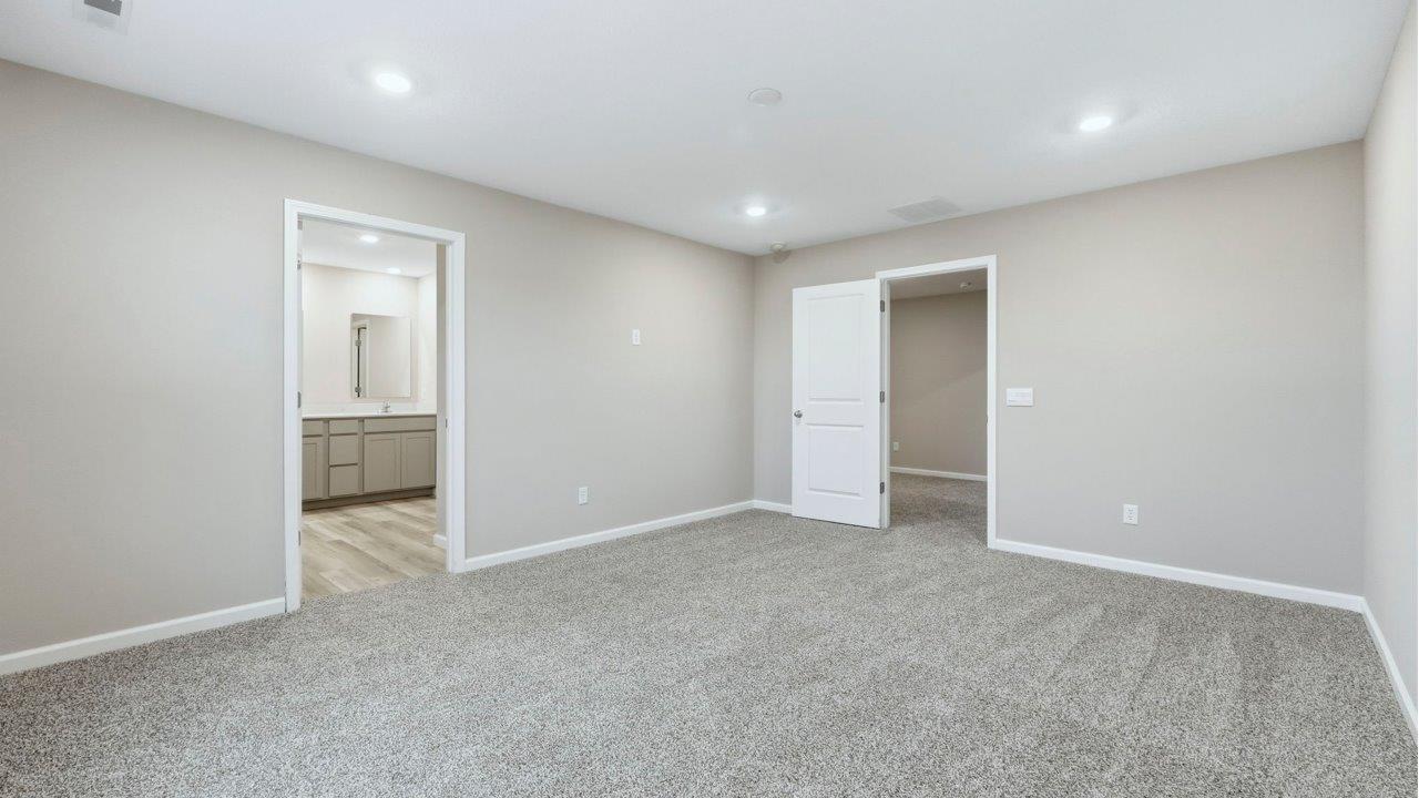 primary bedroom with ensuite bath and closet