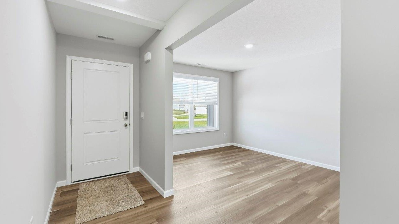 foyer with mohawk eastmont lvp flooring leading to main living area