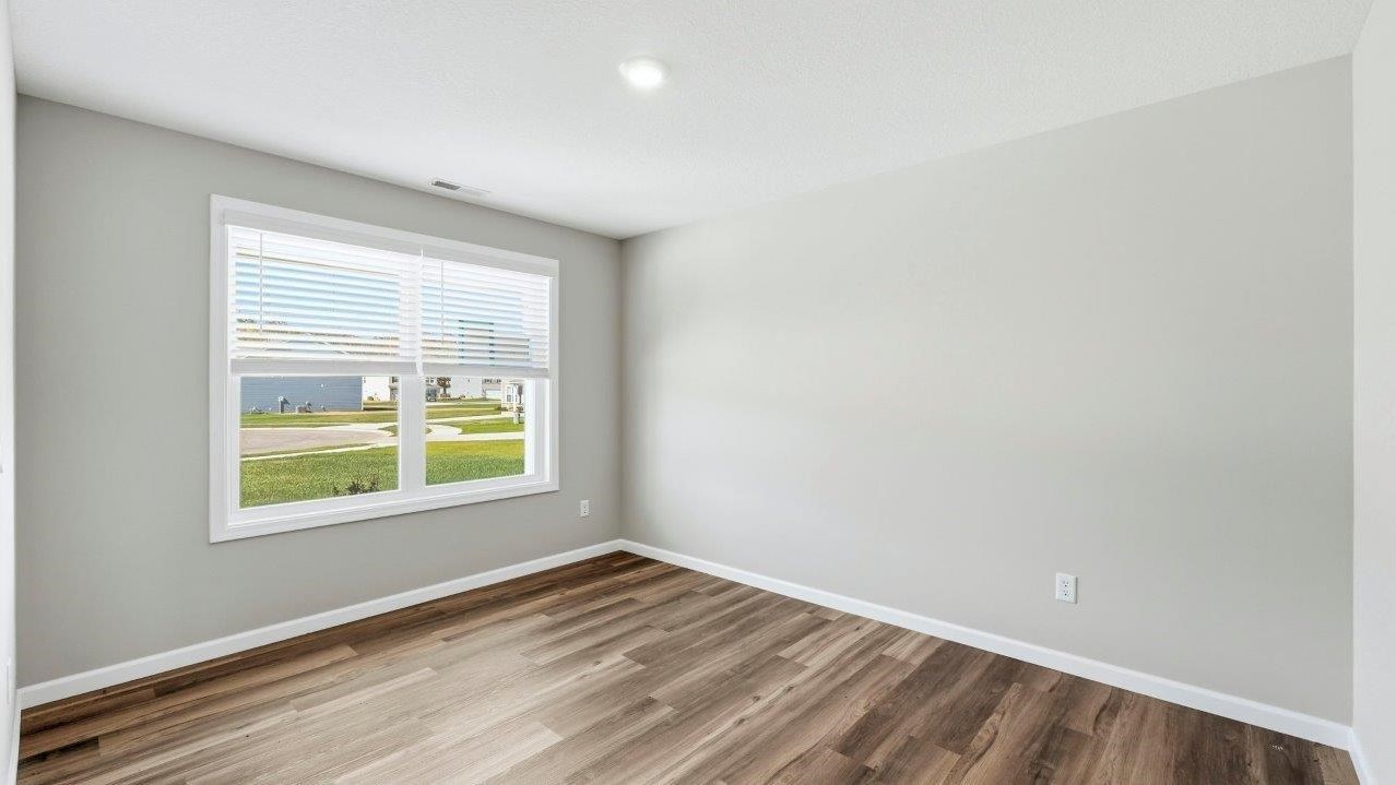 study with lvp flooring, 2 windows, and popular grey walls
