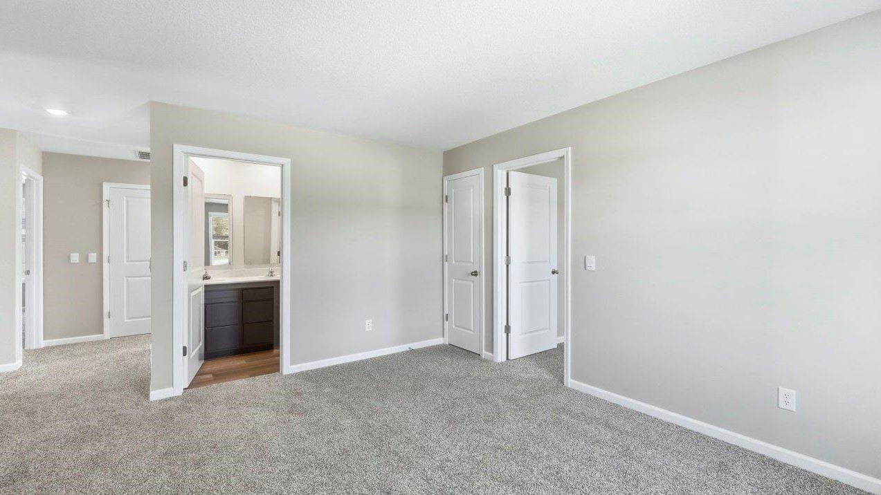 loft with carpet flooring and painted popular grey walls located near full bathroom