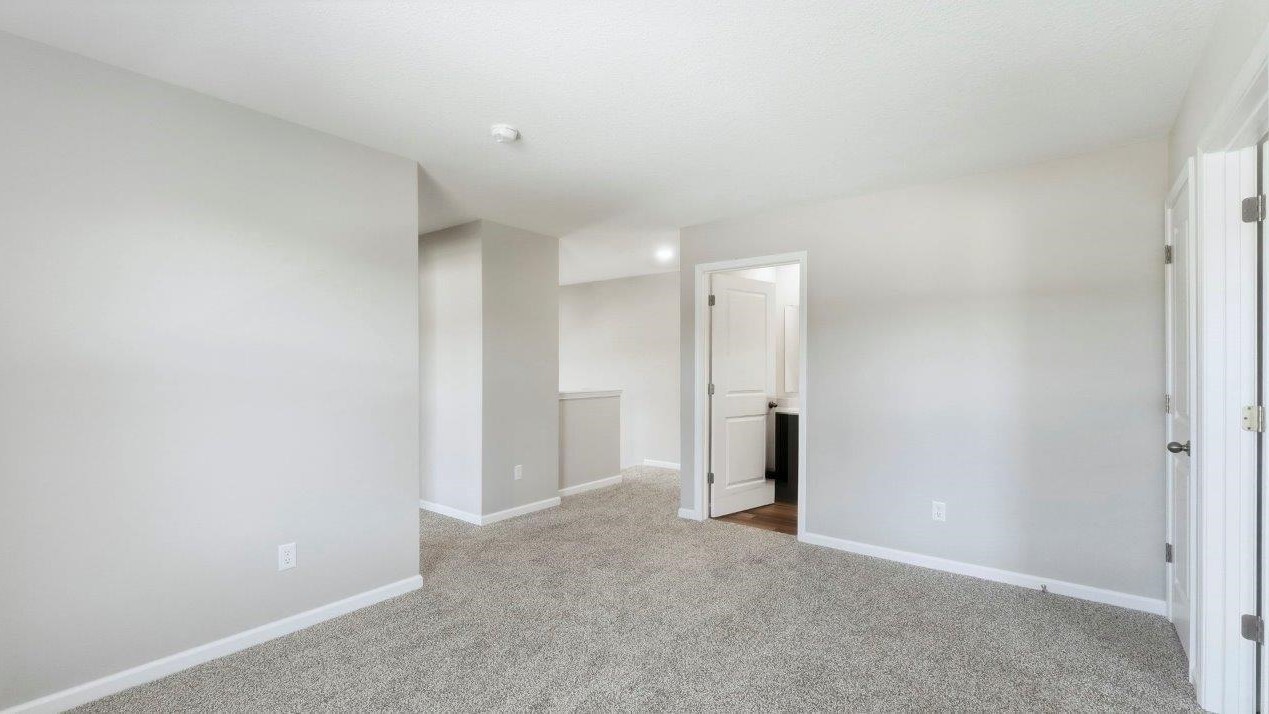 loft with carpet flooring and painted popular grey walls located near full bathroom