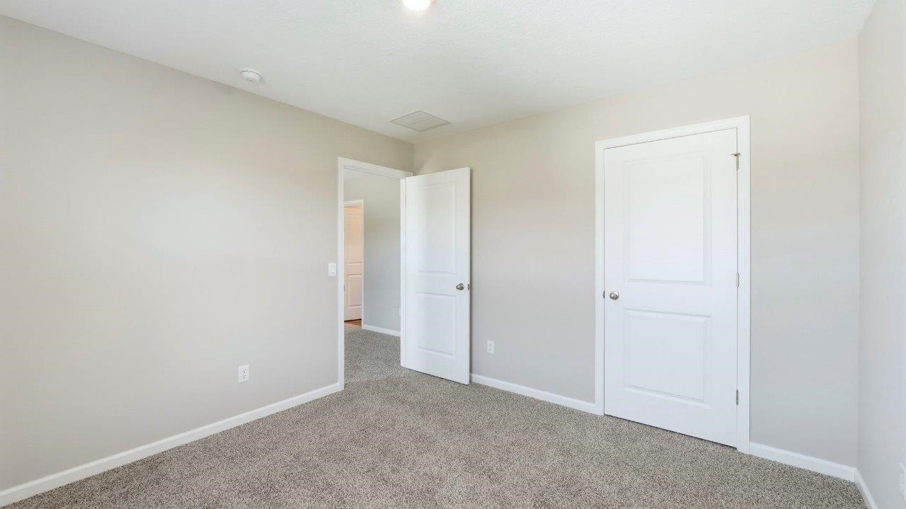 bed 3 with 2 windows, carpet, and closet