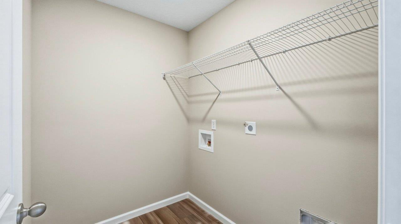 laundry room with built-in shelf, hookups for washer/dryer, and lvp flooring