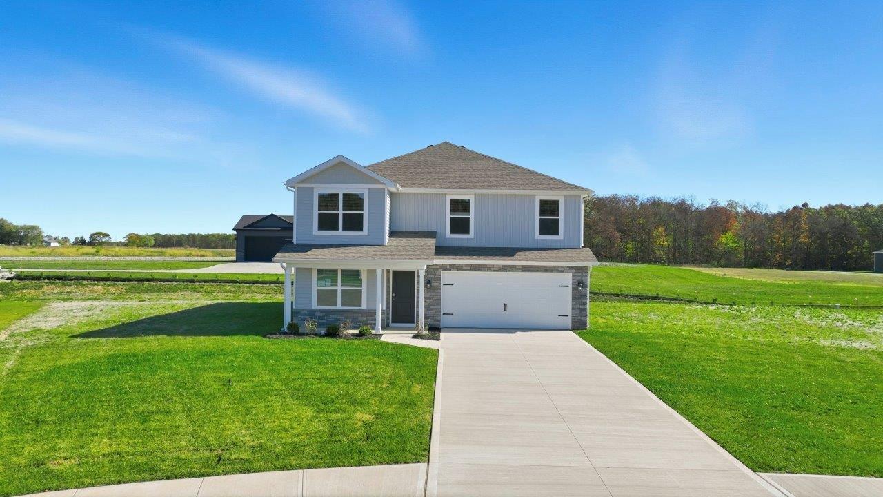 parlor bluffs stamford exterior with sodded yard, front porch, 2 car garage, and landscaped