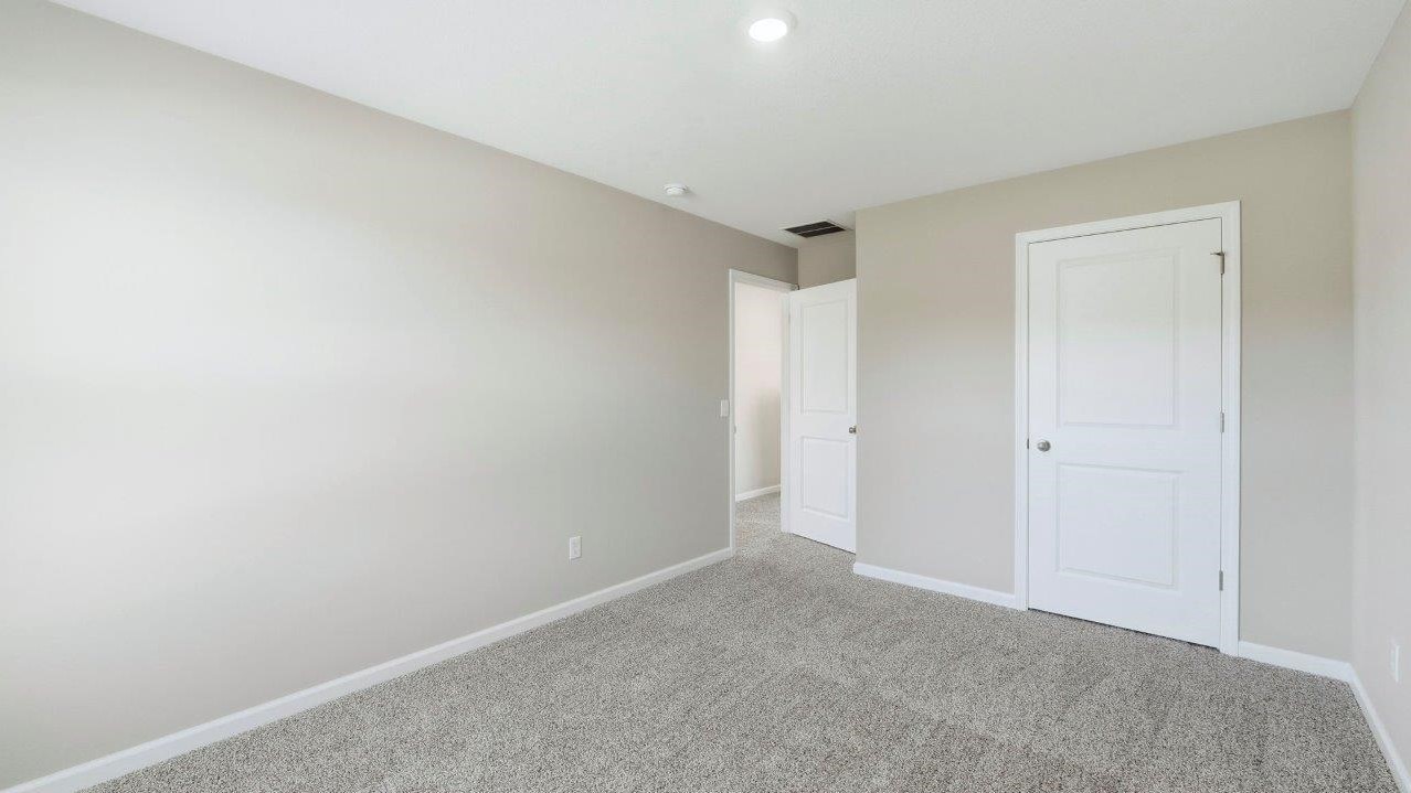 bedroom 2 with carpet, 1 window, and closet