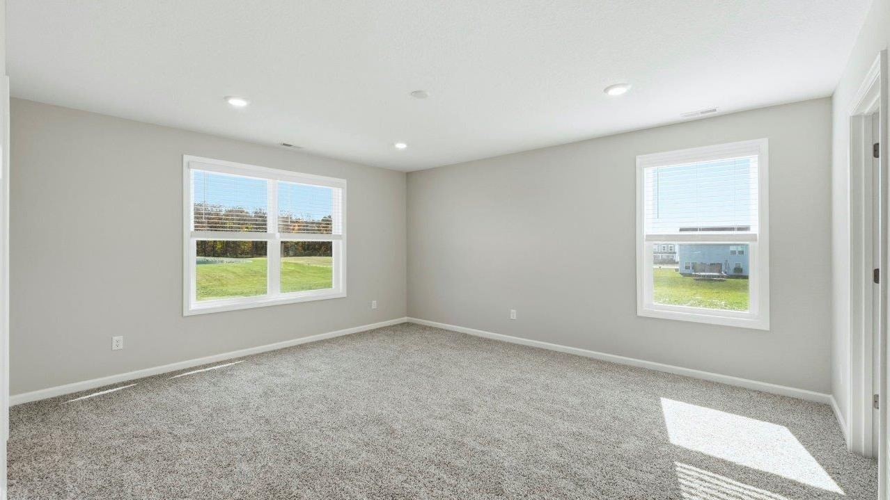 primary bedroom with carpet and ensuite bath and closet