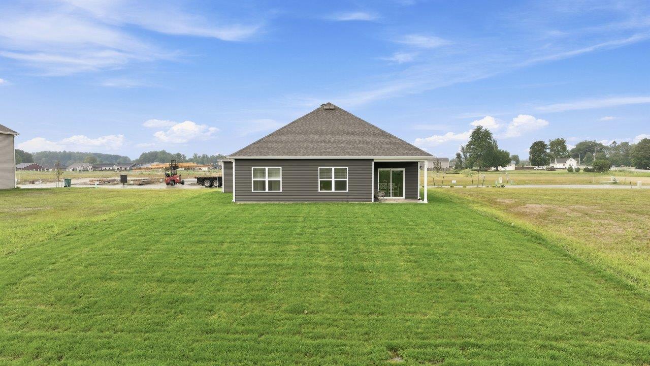 sierra ridge chatham model home backyard exterior with concrete covered patio