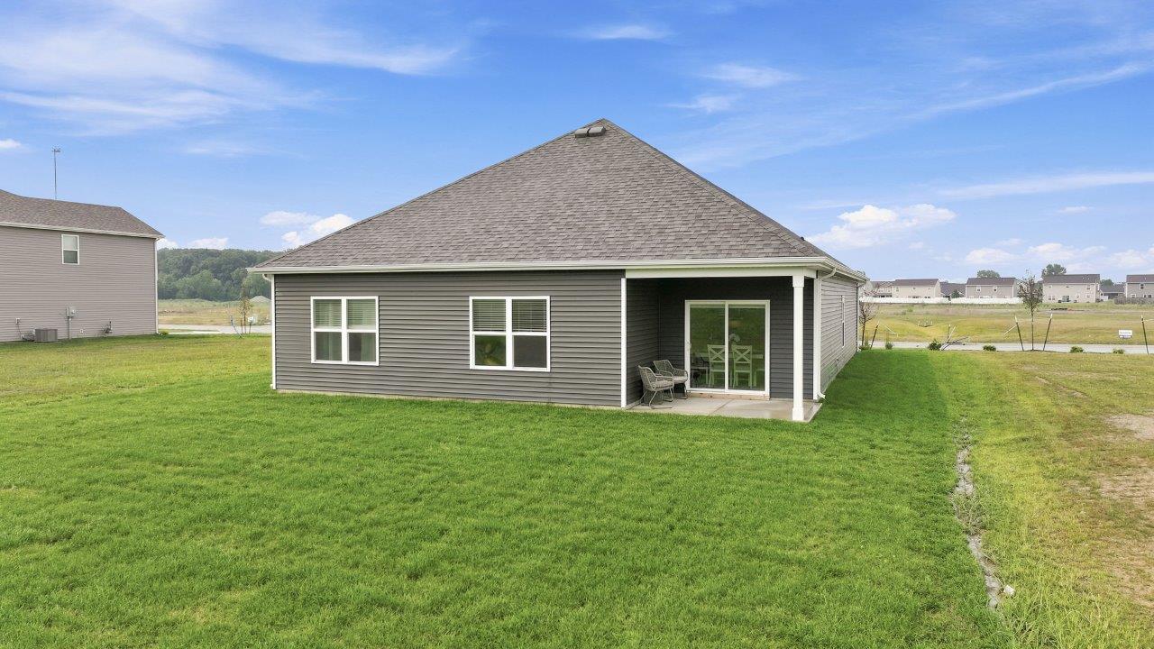 sierra ridge chatham model home backyard exterior with concrete covered patio