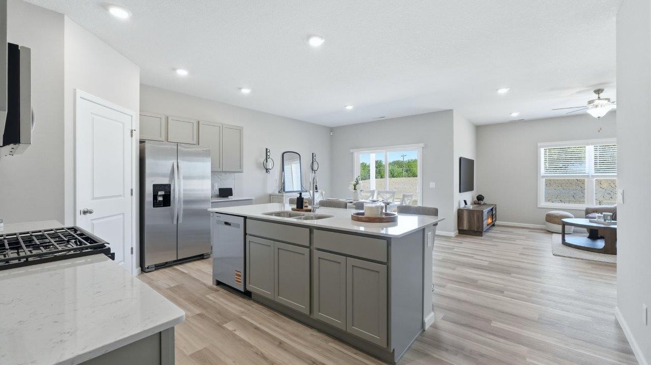 sierra ridge chatham kitchen gray cabinets, quartz counters, stainless steel appliances, corner pantry, and spacious island with bar seating