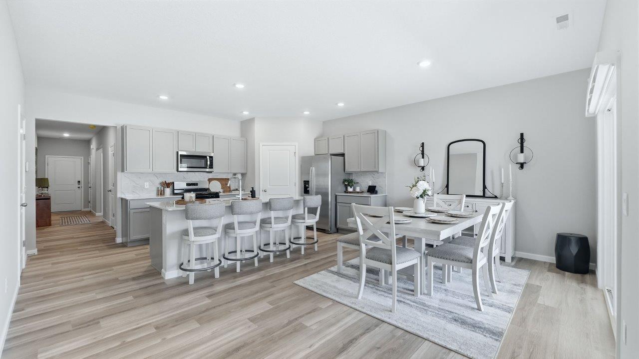 sierra ridge chatham kitchen gray cabinets, quartz counters, stainless steel appliances, corner pantry, and spacious island with bar seating