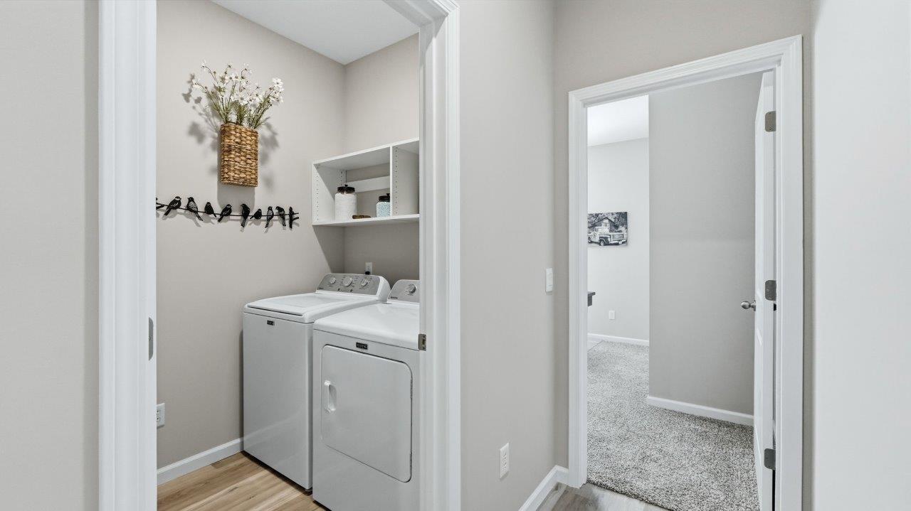 sierra ridge chatham laundry room with shelving, washer, and dryer
