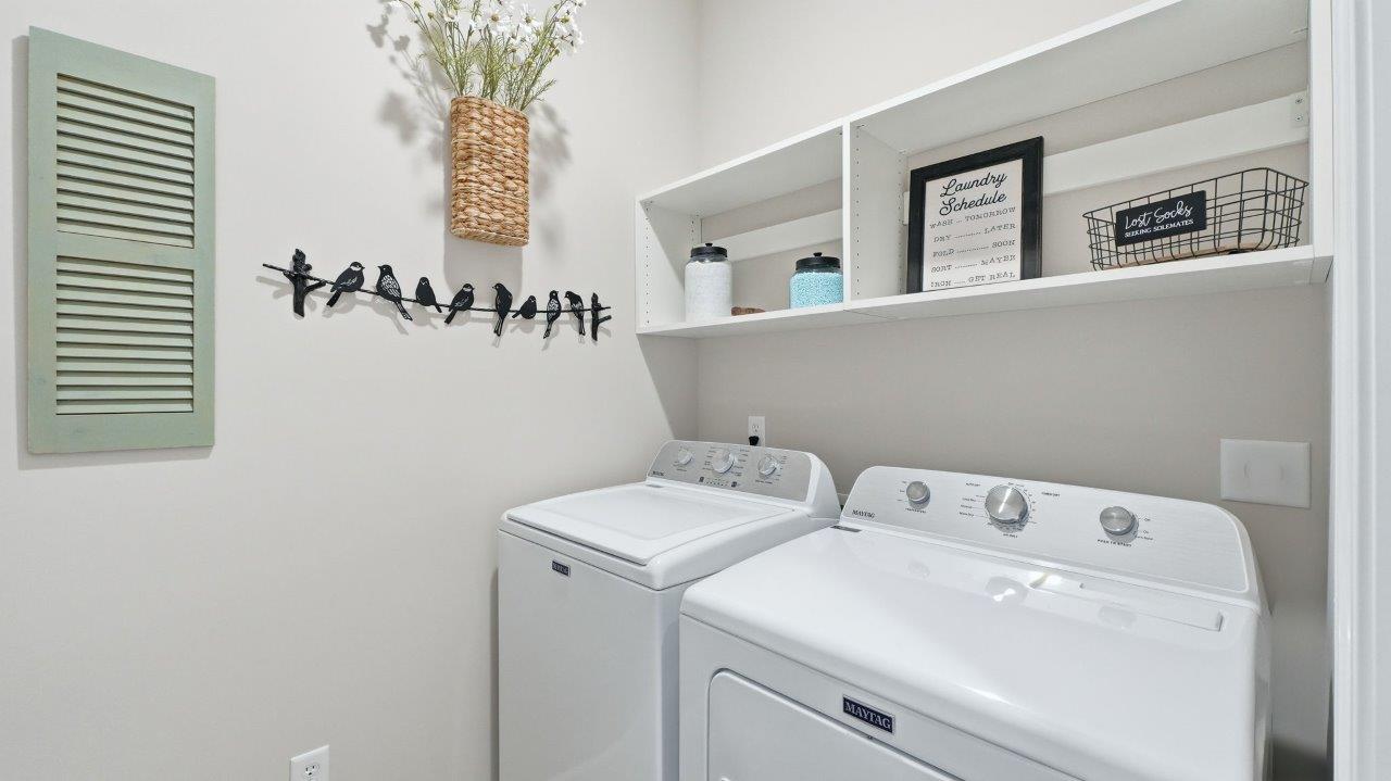 sierra ridge chatham laundry room with shelving, washer, and dryer