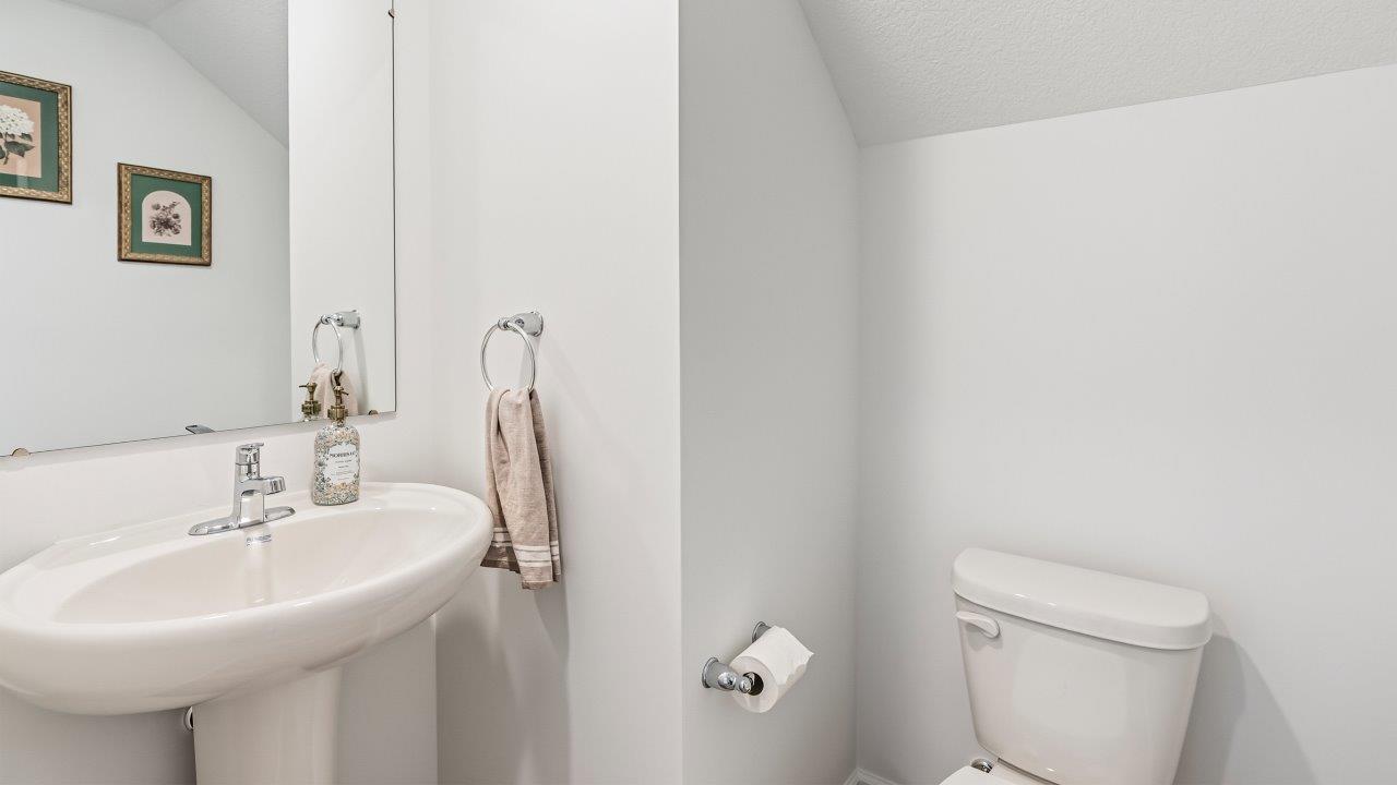 Whispering Pines Pattison Model - first floor powder room with pedestal sink and lvp flooring