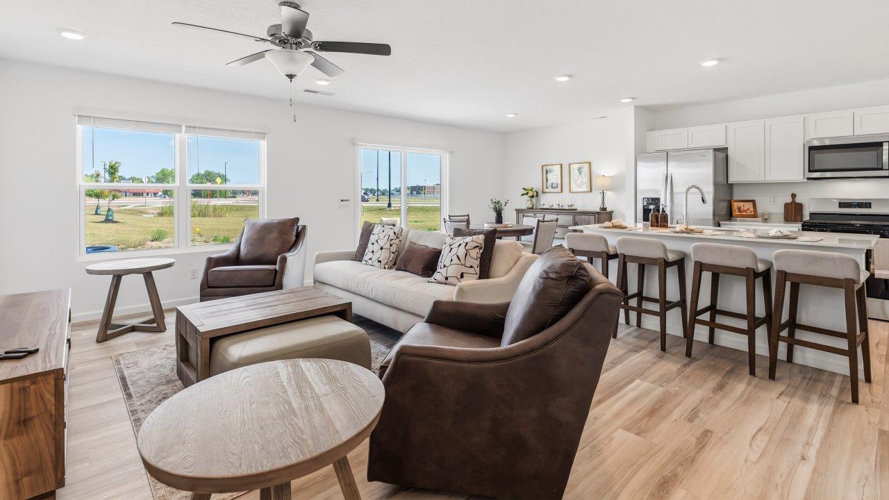 Whispering Pines Pattison Model - open layout living room with lvp flooring, ceiling fan, and white walls