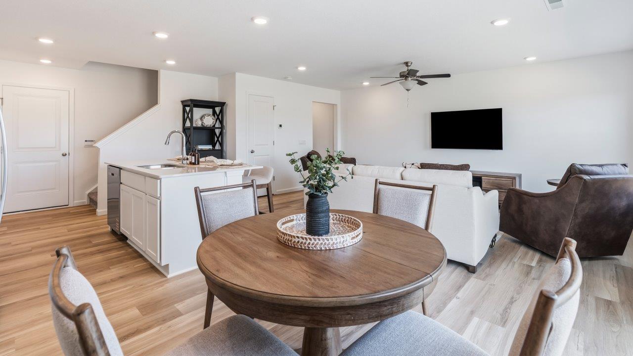 Whispering Pines Pattison Model - casual dining room with dining table, lvp flooring, and sliding glass door to backyard patio